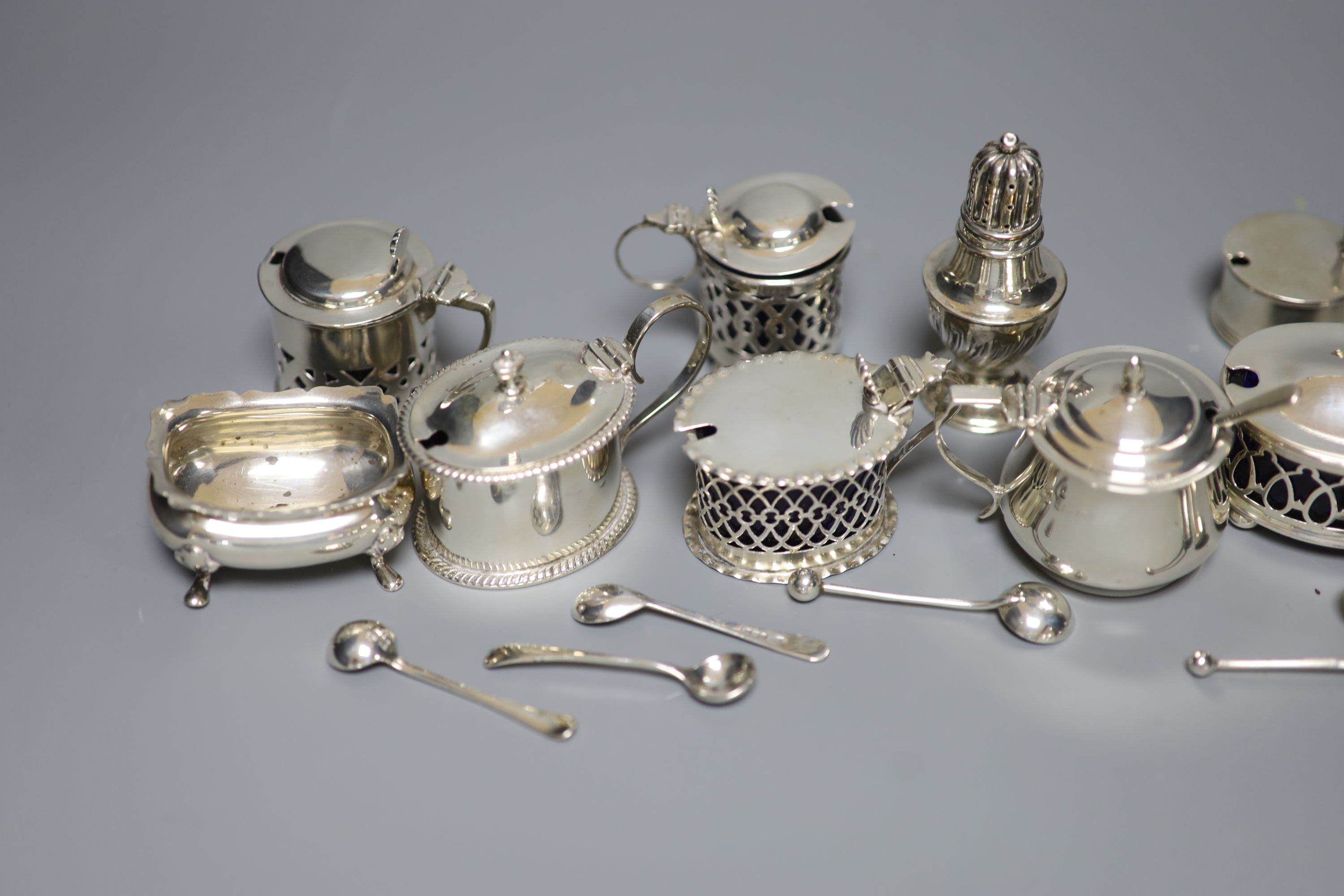 A pair of oval silver salts and spoons, nine small silver mustards, a pepper and seven various condiment spoons, approx 11.5oz